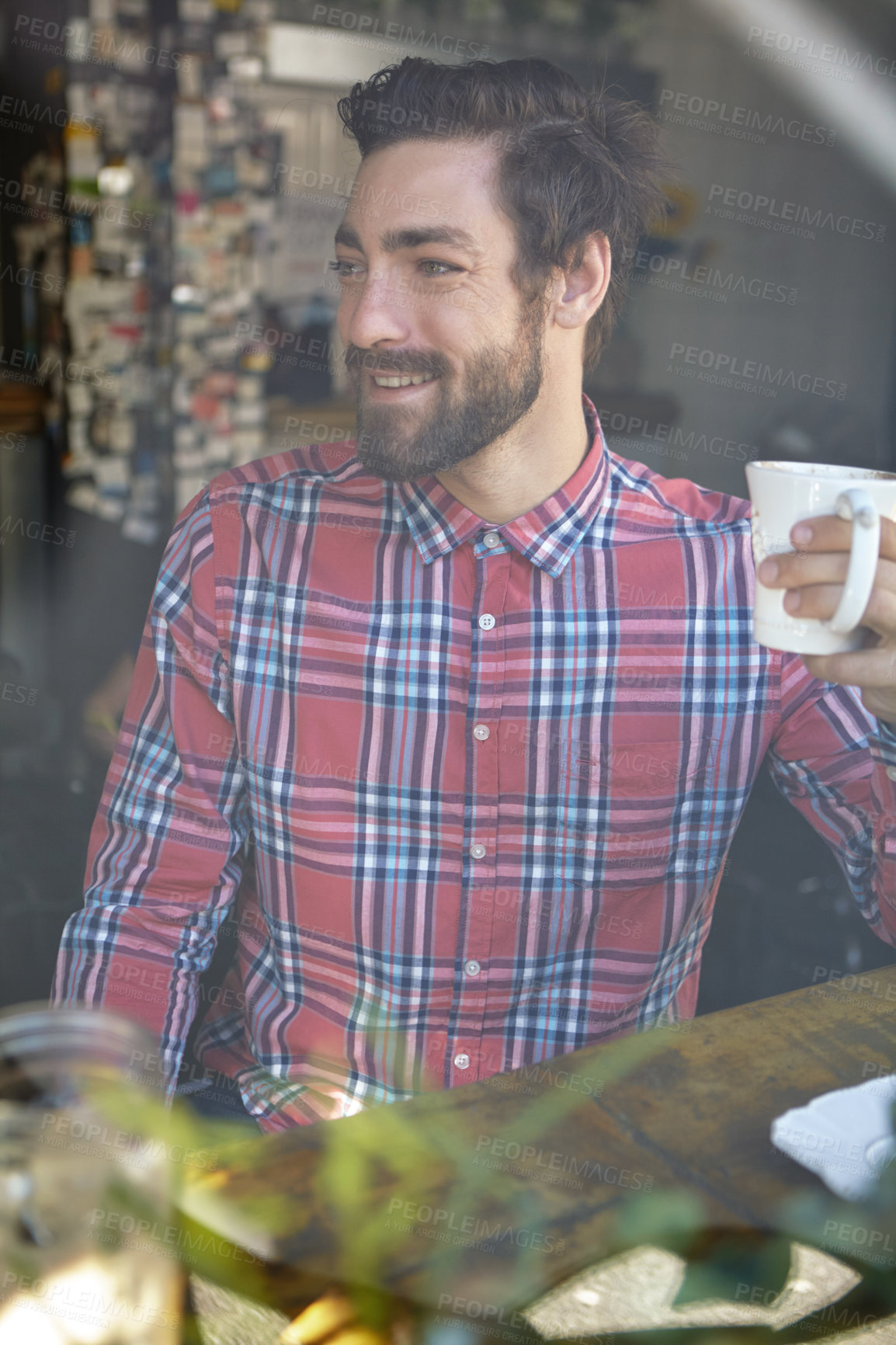 Buy stock photo Shot of a young man drinking coffee in a cafe