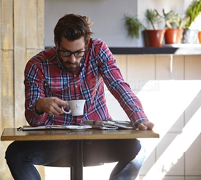 Buy stock photo Shot of a young man having coffee at a cafe