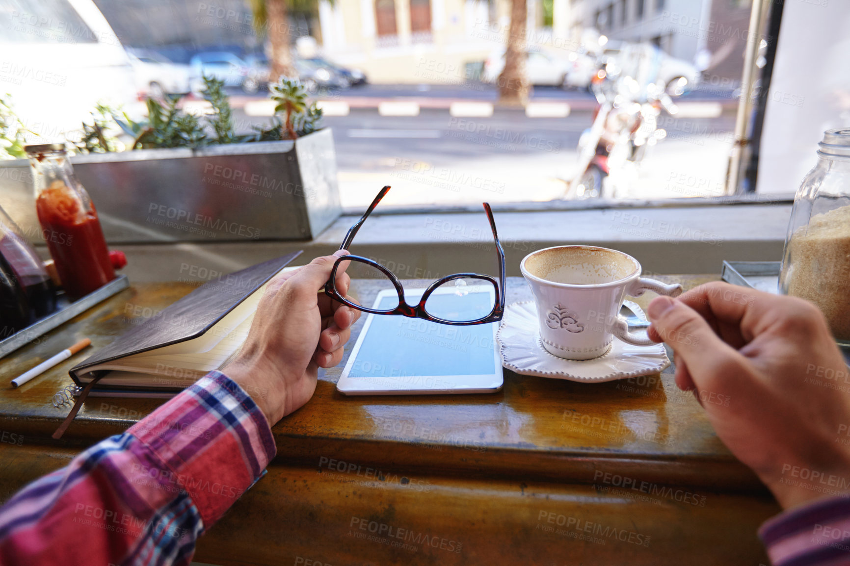 Buy stock photo Cropped shot of man with a tablet, diary and coffee cup at a cafe counter