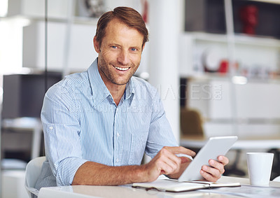 Buy stock photo Cropped portrait of a mature businssman using a digital tablet at his desk in the office