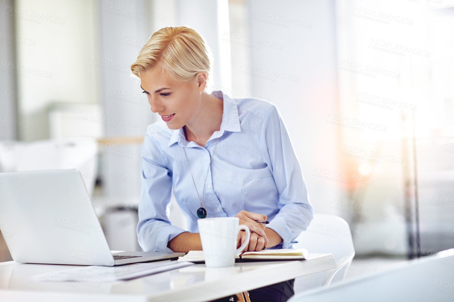 Buy stock photo Cropped shot of a young businesswoman using a laptop at her desk