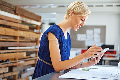 Buy stock photo Cropped shot of a young businesswoman working on her tablet in the office