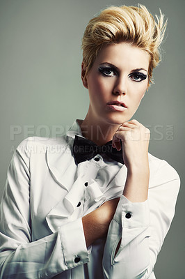 Buy stock photo Studio shot of a beautiful young woman wearing a shirt and bow tie against a gray background