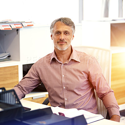 Buy stock photo Cropped portrait of a mature businessman sitting at his desk