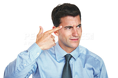 Buy stock photo Studio shot of a young businessman gesturing insultingly towards his head against a white background