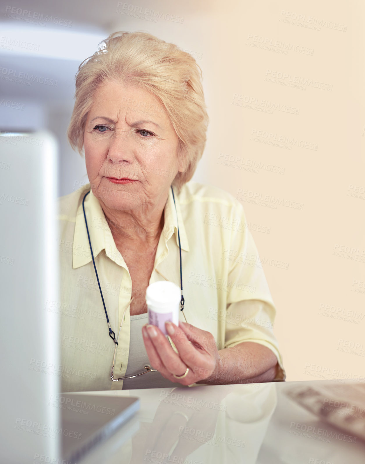 Buy stock photo Shot of a senior woman researching her medication online