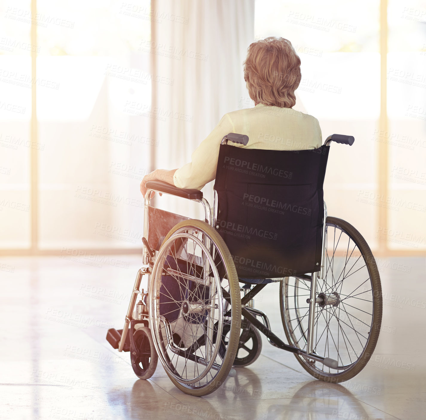 Buy stock photo Rearview shot of a senior woman sitting in her wheelchair at home