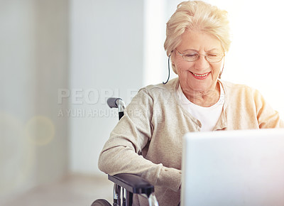 Buy stock photo Shot of a senior woman using a laptop while sitting in a wheelchair