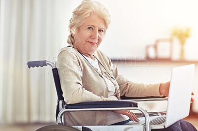 Buy stock photo Shot of a senior woman using a laptop while sitting in a wheelchair