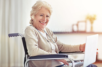 Buy stock photo Shot of a senior woman using a laptop while sitting in a wheelchair