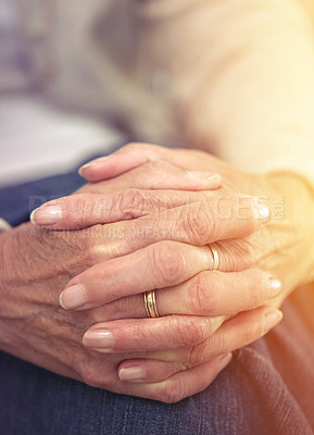 Buy stock photo Hands, retirement and closeup with a mature woman indoor thinking about a past memory of nostalgia. Fingers, wrinkles and old age with a senior female pensioner sitting in her home feeling lonely