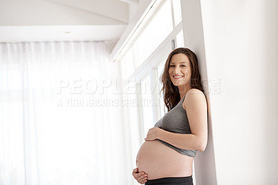 Buy stock photo Cropped portrait of a young pregnant woman standing in her home