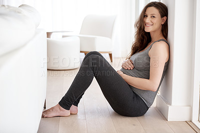 Buy stock photo Full length portrait of a young pregnant woman sitting in her home