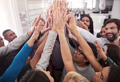 Buy stock photo Shot of a business team raising their hands while standing in a huddle