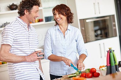 Buy stock photo Shot of a happy mature couple cooking a healthy meal together at home