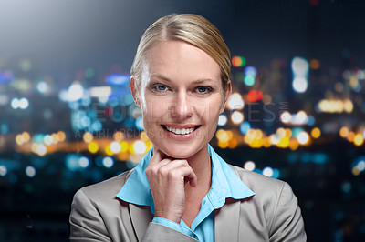 Buy stock photo Cropped portrait of a businesswoman standing against a cityscape at night