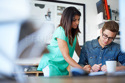 Buy stock photo Shot of two designers working together on a project