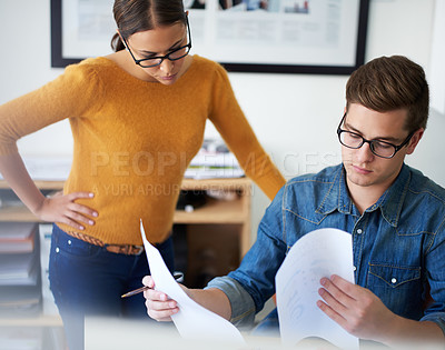 Buy stock photo Shot of two colleagues working together in the office
