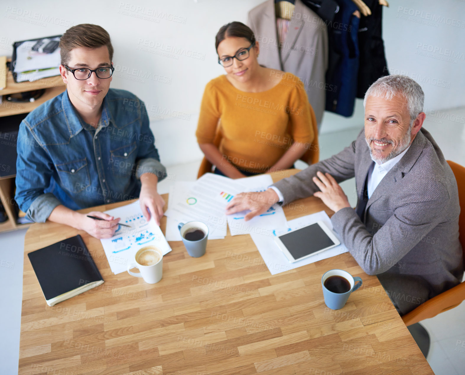 Buy stock photo Portrait of creative businesspeople having a meeting around a table