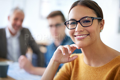 Buy stock photo Portrait of a young businesswoman with her coworkers in the background