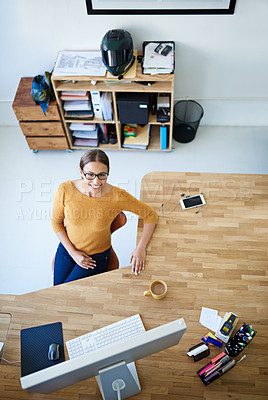 Buy stock photo High angle portrait of a young female designer at her desk
