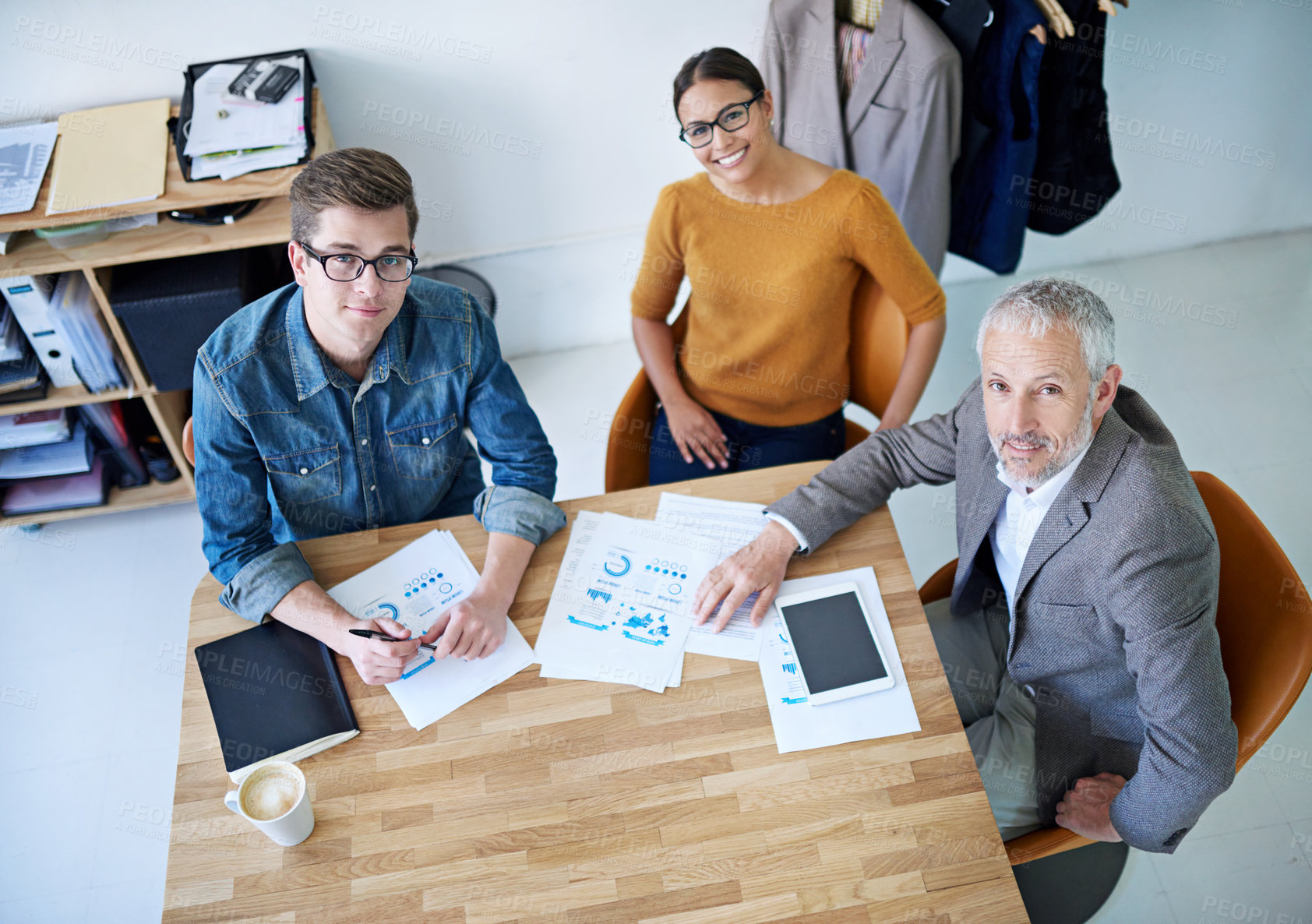 Buy stock photo Portrait of creative businesspeople having a meeting around a table