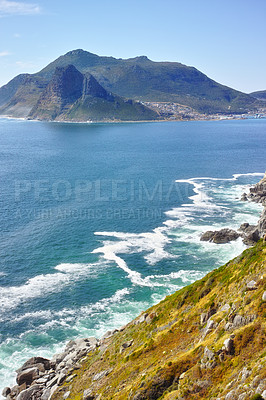 Buy stock photo Mountain, sea and waves by rock with nature for travel adventure, aerial view and holiday by water. Natural environment, landscape and ocean for scenery, tourism and summer vacation in South Africa