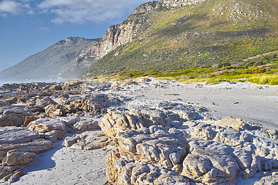 Buy stock photo Landscape of boulders and mountains on rocky beach in Cape Town, South Africa. Empty beach during a summer day on a weekend outside with copyspace. Enjoying holiday and vacation overseas and abroad