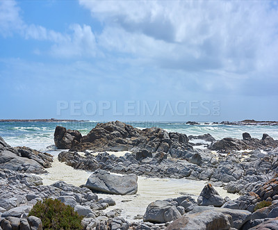 Buy stock photo Rocky shore, ocean and waves environment with rocks and horizon for peace, travel destination and holiday location. Coast, blue sky and sea water for vacation landscape, panorama or scenery in nature