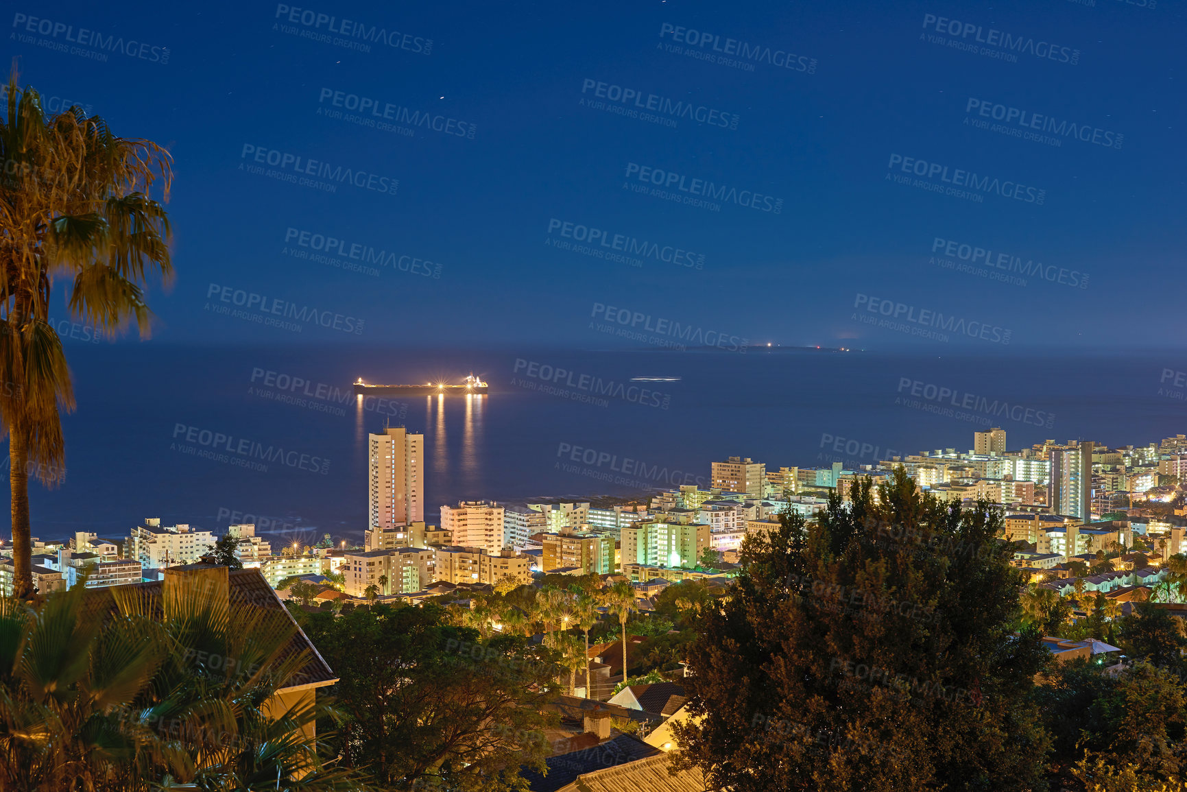 Buy stock photo Cityscape, trees and night or urban landscape with buildings, boat and sea or outdoor. Development, skyline and port or water for shipping, cargo and tourism or travel for architecture or hospitality