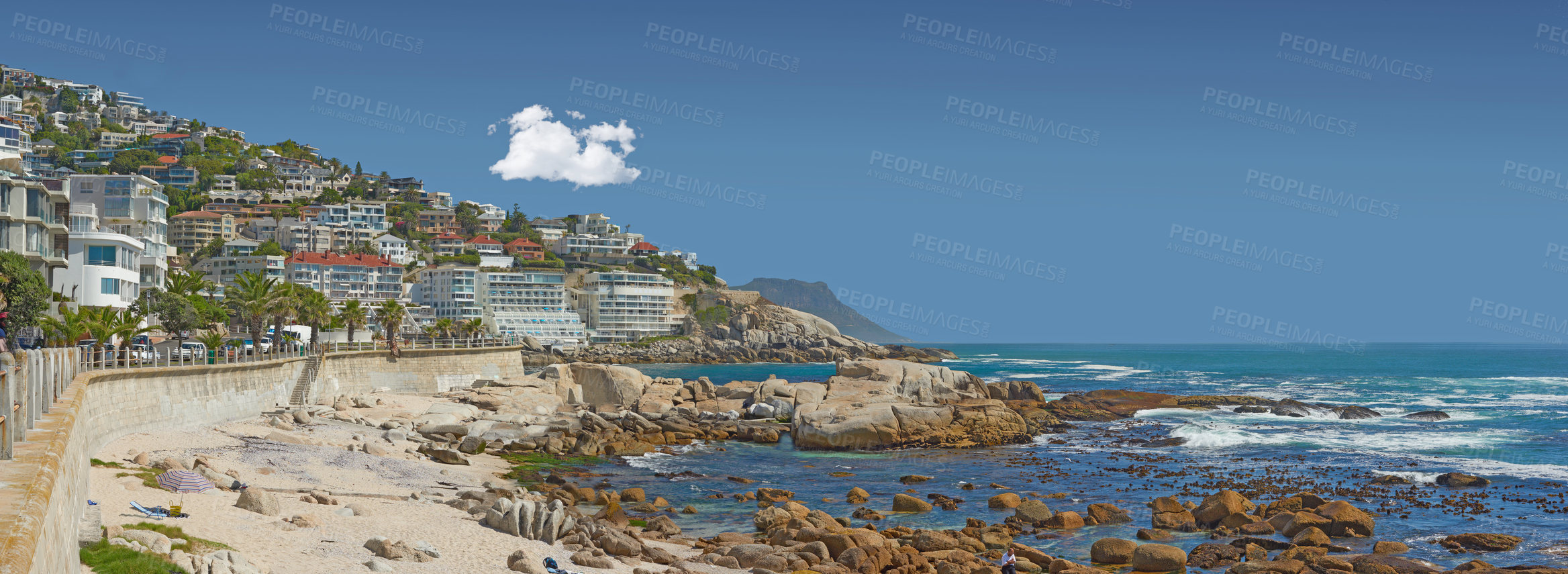 Buy stock photo Buildings, ocean and sky at beach for summer, water and sand or clouds with sunshine. Environment, landscape and waves or outdoor for travel, tourism and adventure in nature for holiday or vacation 