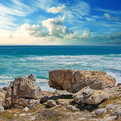 Buy stock photo Rocks, ocean and water in nature outdoor for travel destination, coat environment and natural beauty. Blue sky, beach and scenery for seaside peace, tourism journey with adventure location of view