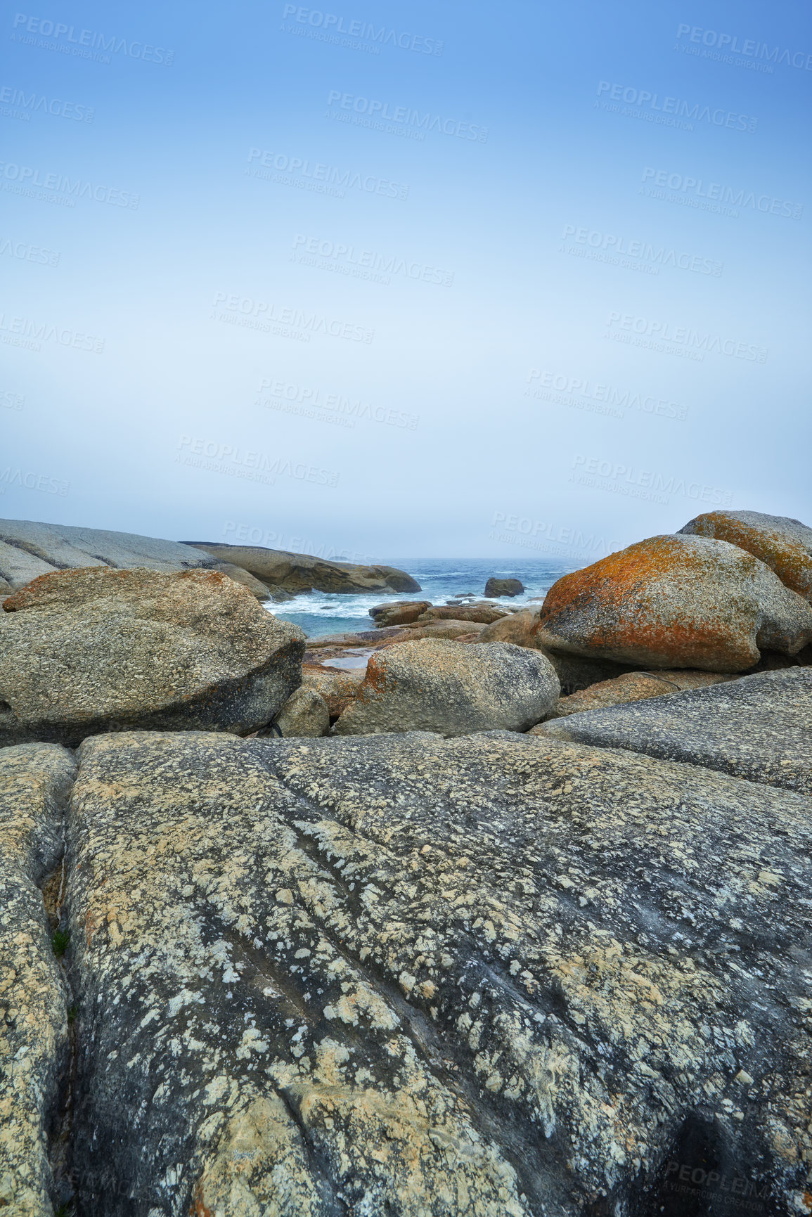 Buy stock photo Rocks, ocean and blue sky in nature for summer, water and sand or plants with sunshine. Environment, landscape and waves or outdoor for travel, tourism and adventure at beach for holiday or vacation 