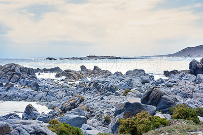 Buy stock photo Coastline, sea and waves landscape with horizon and rocks for peace, travel destination and holiday location. Beach, cloudy sky and ocean water for vacation environment, skyline and scenery in nature