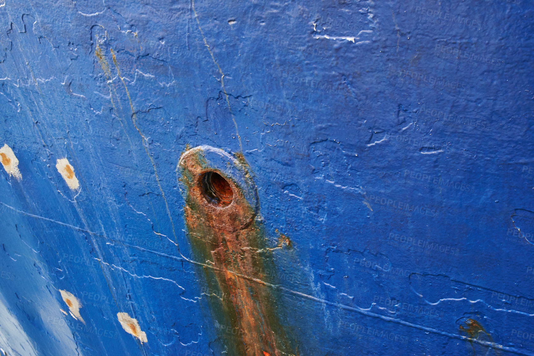 Buy stock photo Abandoned and rusty limber hole on the side of docked ship outside. Closeup of rust stained hawsehole used for draining water on the hull of a nautical boat in a dockyard and port overseas and abroad