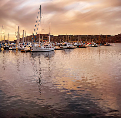 Buy stock photo Sunset, water and boat in port for journey, travel and adventure in village or small town. Yachts, sky or clouds and holiday or luxury for sailing or outdoor, destination and location by ocean or sea