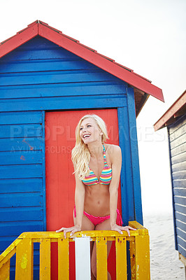 Buy stock photo Shot of a young woman in a bikini at the beach