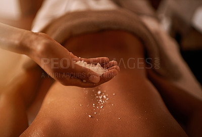 Buy stock photo Hand, back and salt at spa for massage, skin care and wellness for luxury, holistic therapy and peace. Grain, exfoliate and health for lifestyle, body and person on table, calm and natural