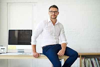 Buy stock photo Cropped portrait of a businessman sitting a desk in his office
