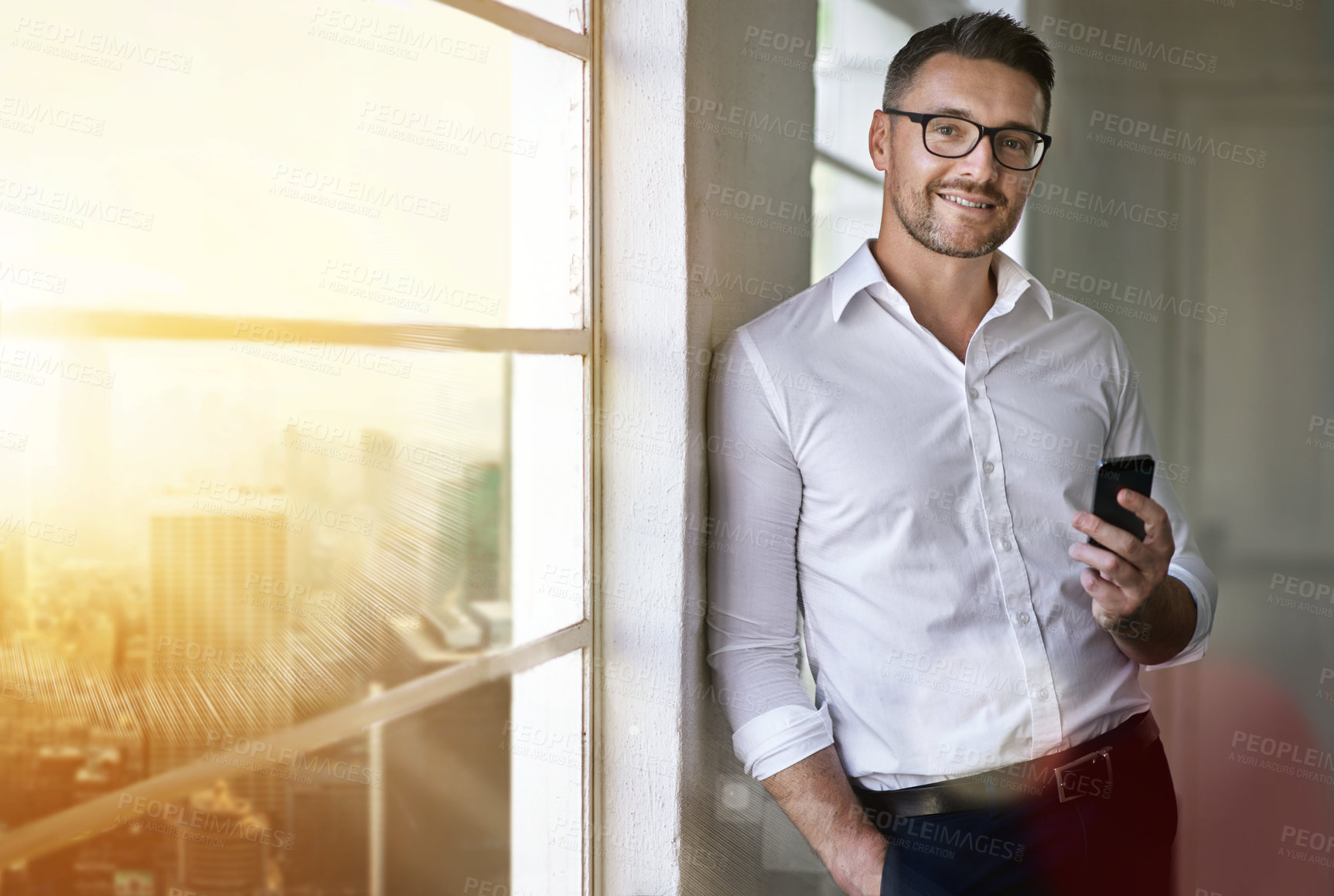 Buy stock photo Cropped portrait of a businessman sending a text in his office