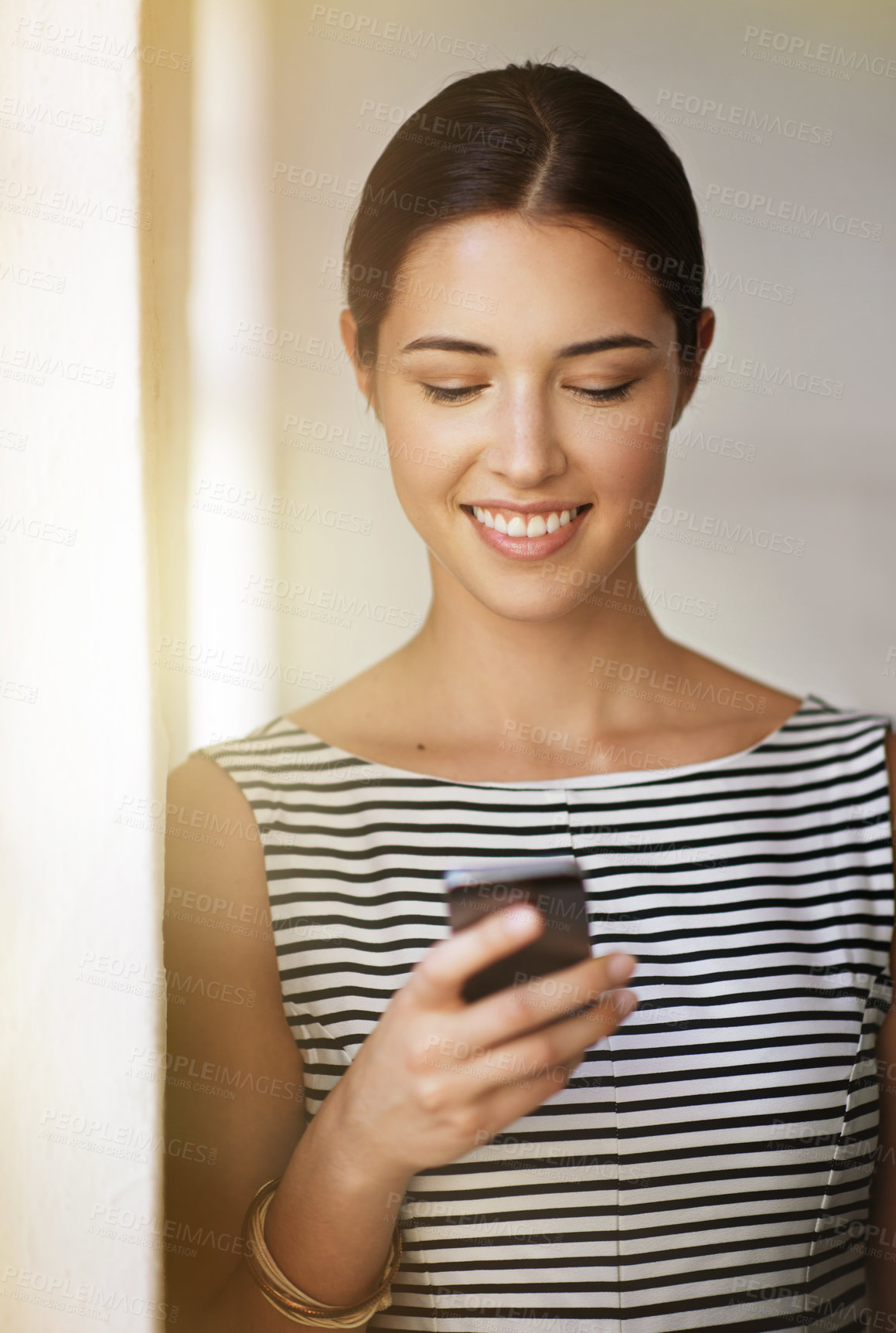 Buy stock photo Texting, woman and happy at office with smartphone for communication, networking and good news. Business, female employee and smile or confident as real estate agent on property website for sale