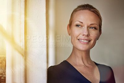 Buy stock photo Cropped shot of a businesswoman looking out of a window in her office