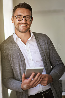 Buy stock photo Cropped portrait of a businessman using a digital tablet in his office