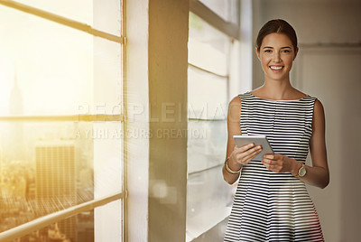 Buy stock photo Cropped portrait of a businesswoman using a digital tablet in her office