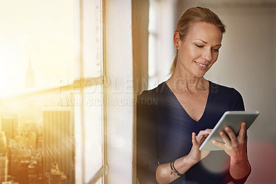 Buy stock photo Cropped shot of a businesswoman using a digital tablet in her office