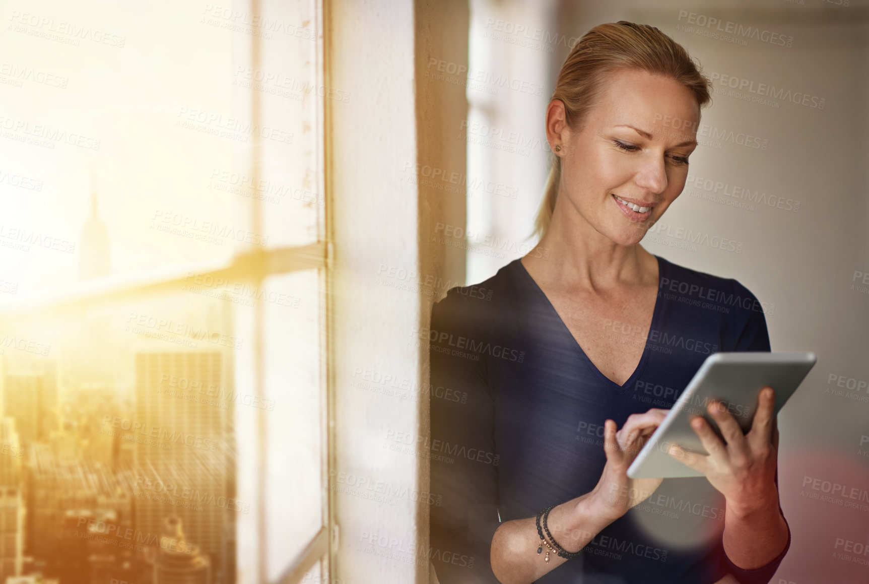 Buy stock photo Cropped shot of a businesswoman using a digital tablet in her office