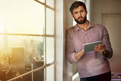 Buy stock photo Cropped portrait of a businessman using a digital tablet in his office