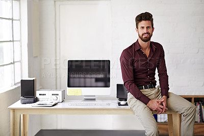 Buy stock photo Cropped portrait of a businessman sitting on a desk in his office