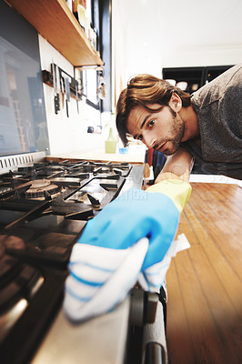 Buy stock photo Shot of a young man cleaning the house