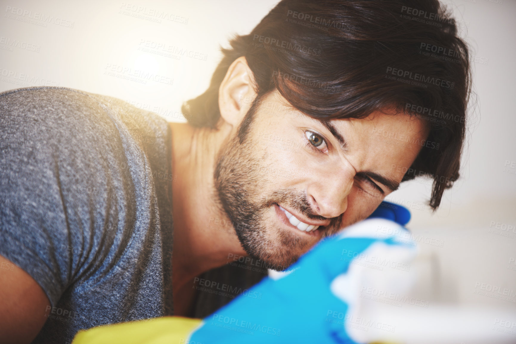 Buy stock photo Shot of a young man cleaning the house